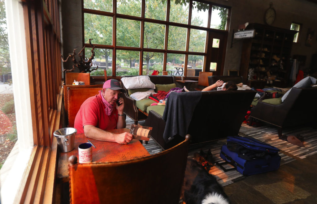Jeff Kunde tries to arrange for trucks to have access to his Kunde Family Winery in order to move product, from the tasting room in Kenwood. Members of the Kunde family have been living in the winery tasting room since being evacuated from their home.(Photo by Christopher Chung)