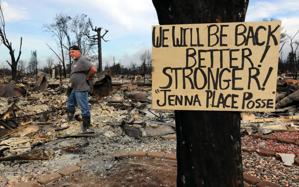 Rick Serdin placed small American Flags in front of every home on Jenna Place on the first day residents could return to their homes in the Coffey Park neighborhood of Santa Rosa. (Photo by John Burgess)