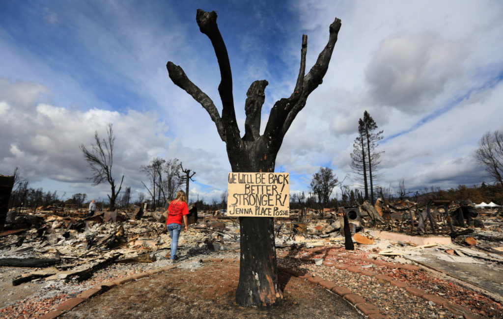 Lacey Tower returns to her Jenna Place home in Coffey Park, Friday Oct. 20, 2017. The sign was put together by her parents. (Photo by Kent Porter)