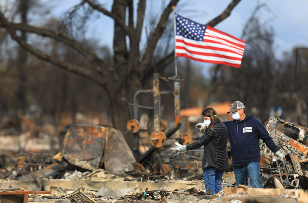 Linda and Jason Miller spot an item of interest in the burned home in Coffey Park, Friday Oct. 20, 2017 in Santa Rosa. (Kent Porter / The Press Democrat)