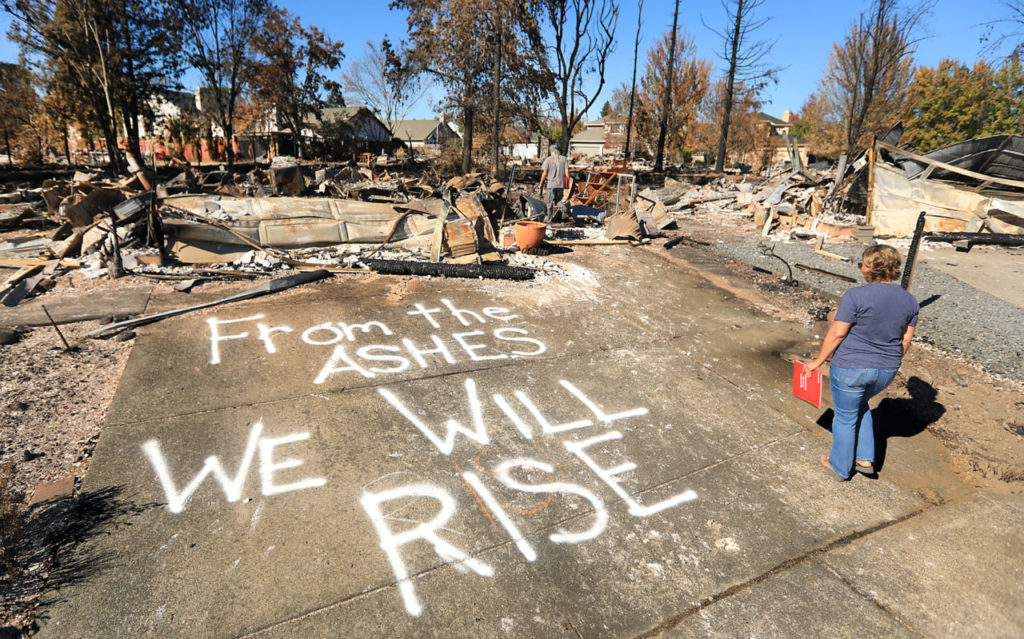 At Coffey Park in Santa Rosa, Traci Lattie and her partner Wayne Hovey intend to rebuild, and are letting everyone know, Monday Oct. 23, 2017. (Photo by Kent Porter)