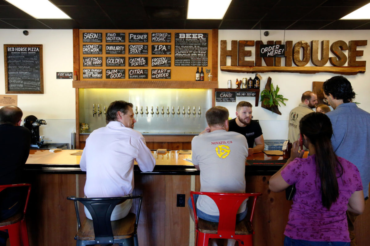 Tasting room server John Brewer, at right, takes customers orders at HenHouse Brewing Company's tasting room in Santa Rosa. (Alvin Jornada/The Press Democrat)