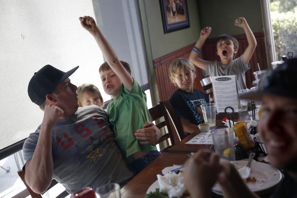 Matt Metzler, his son Jackson, 7, Austin Cooper, 9, and Joey Cerda, 7, react after the USA beat Japan during the World Cup final at Beyond The Glory Sports Bar and Grill on Sunday, July 5, 2015 in Petaluma, California . (BETH SCHLANKER/ The Press Democrat)