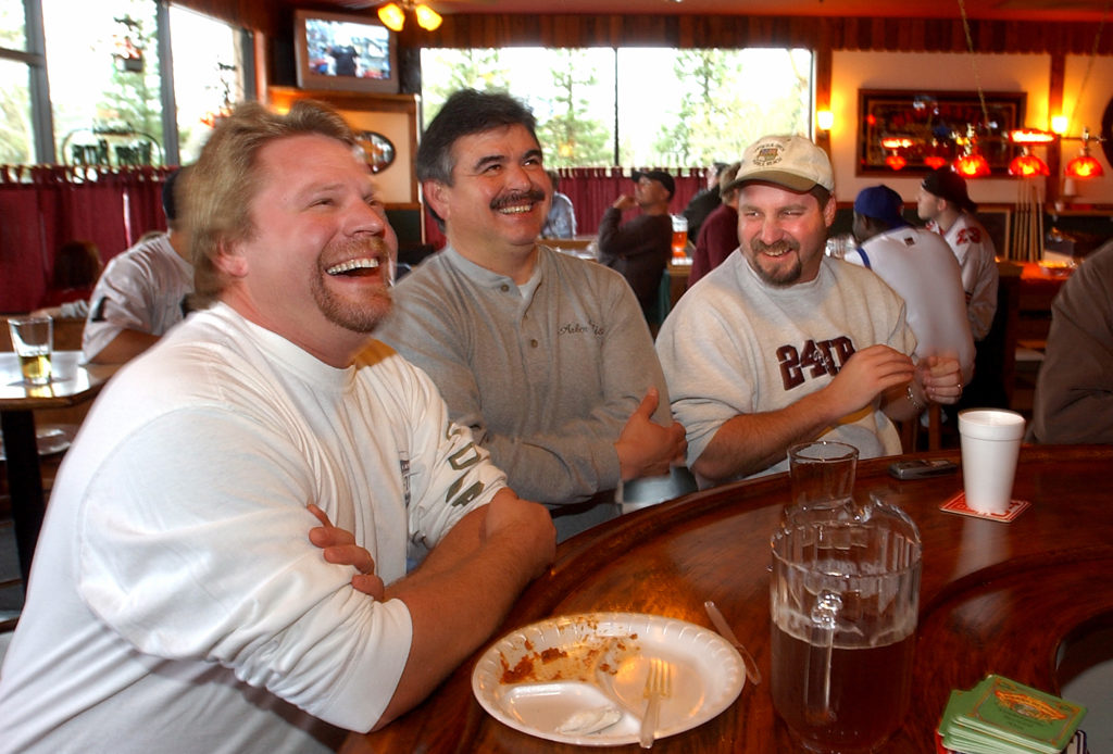 PC: Photo by Christopher Chung/ The Press Democrat Dan White, left, Ralph Padilla and Jim Hubbell laugh as they watch a commercial during the Super Bowl broadcast at Ausiello's West Side Grill on Sunday afternoon, February 8, 2004. 2/2/2004: A1: Dan White, left, Ralph Padilla and Jim Hubbell laugh as they watch a commercial during the Super Bowl broadcast at Ausiello's West Side Grill on Sunday afternoon.