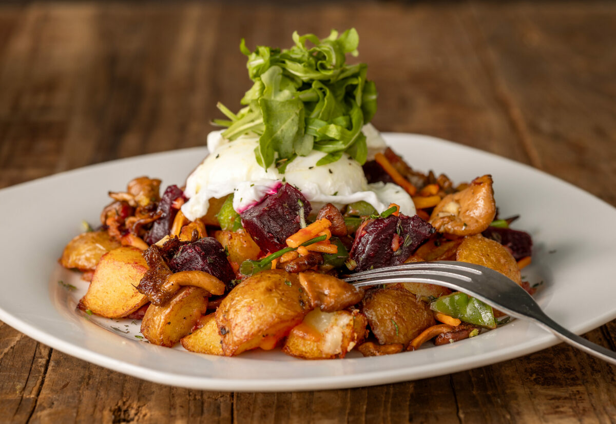 New England Red Flannel Hash with country potatoes, roasted beets, hedgehog mushrooms, corned beef, two eggs and arugula from J & M’s Midtown Cafe, Thursday, Jan. 18, 2024, in Santa Rosa. (John Burgess / The Press Democrat)
