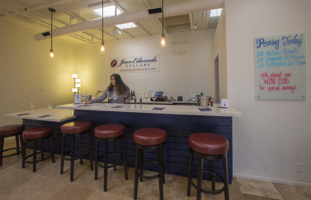Jessica Saldana, tasting room manager at Jean Edwards Cellars in the Sonoma Court Shops (otherwise known as Vine Alley), prepares to received wine tasters on Sunday afternoon. (Photo by Robbi Pengelly/Index-Tribune)