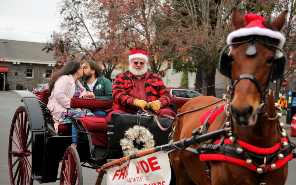 Sweethearts of 13 years, Lacinda Moore and James Kelley sealed the deal with a kiss when he asked her to marry him.Families enjoyed holiday horse and carriage rides in historic Railroad Square in Santa Rosa, Sunday December 24th, 2017. (photo Will Bucquoy/for the Press Democrat).