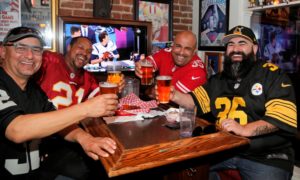 Each representing different teams, friends (from left) Ernie Garnica, Marcell Nesmith, Mark Chavez and Jimmy Garnica toasted to an exciting Superbowl match up at Ausiello's sports bar in Santa Rosa, Sunday February 4th, 2018. (Photos Will Bucquoy/for the Press democrat)