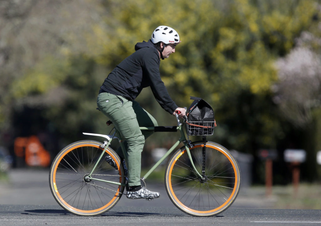 Ian Conover, an owner of Relax and Eat Bread, delivers his bread by bicycle after freshly baking it on Thursday, February 15, 2018 in Sonoma, California . (BETH SCHLANKER/The Press Democrat)