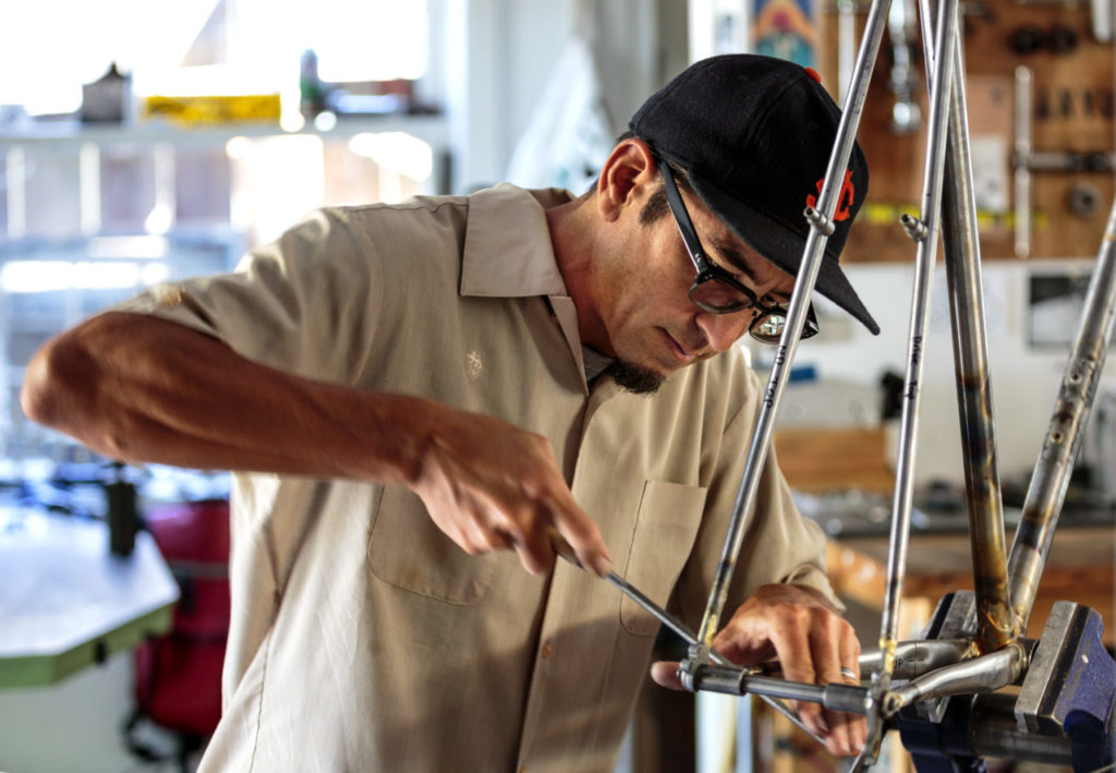 Tom Fitzgerald making a bike frame in his garage/workshop