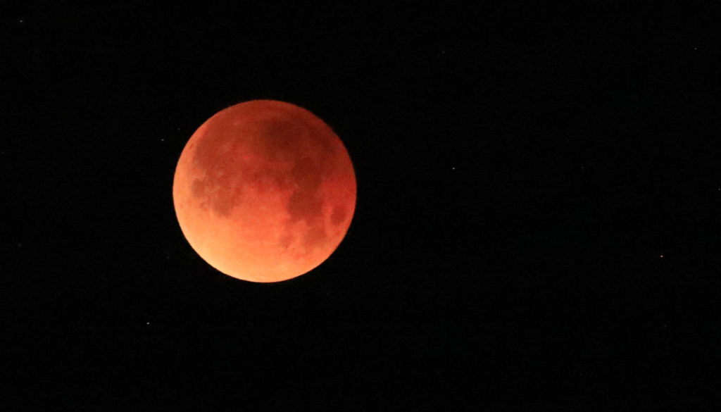 The super moon, part of a celestial trifecta, involving a blue moon is covered by the shadow of the earth hangs over the Alexander Valley near Geyserville, Wednesday Jan. 31, 2018. (Kent Porter / Press Democrat) 2018