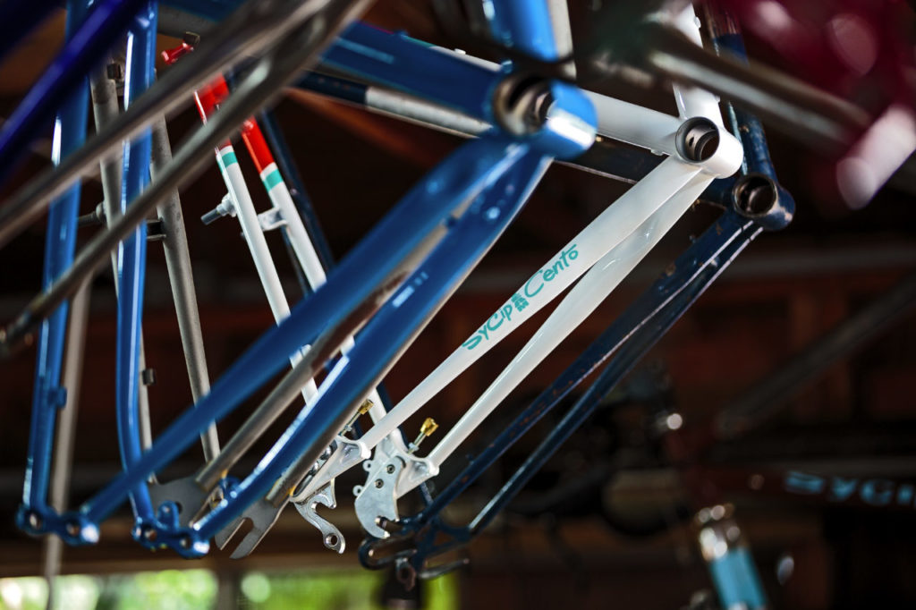 Jeremy Sycip, builder of custom bikes with some of his bikes and an exploded view of a bike