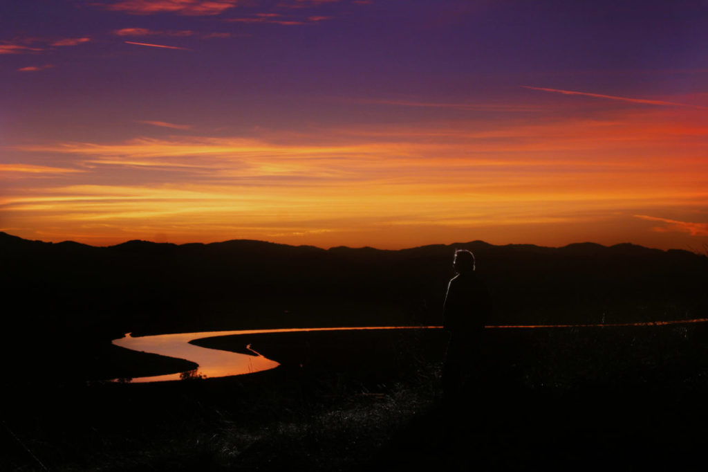 6/3/2007: 114: "This view of the Petaluma River from the top of Keller Estate is one of my favorites, whether on a clear evening like this or when the thick fog rolls up from the Bay into the Petaluma Gap. This fog creates the cool-climate vineyard from which we create our bright Chardonnays and lush Pinot Noir." MICHAEL McNEILL: McNeill is the winemaker at Keller Estate Winery in Petaluma. PC: Keller Estate winemaker Michael McNeil looks at a stripe of the Petaluma River that is lit up at sunset. Shot on November 11, 2006 for Summer Savor magazine. ( Press Democrat / Charlie Gesell ) srps