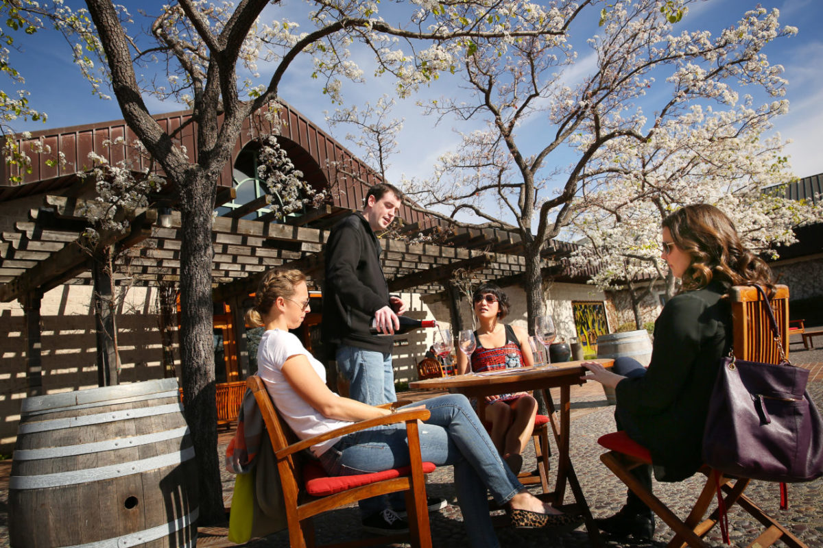 2/5/2014: D1: Adam Gaines, second from left, pours Keller Estate wines for, from left, Casey Burke, Lisa Nourse and Stephanie Simunovich of San Francisco. Keller Estate is one of the vineyards in the Petaluma Gap, an area where the Pacific winds blow through a break in the coastal range southeast to the San Francisco Bay. It is known for producing grapes with powerful flavors. PC: Adam Gaines, second from the left, pours samples of wine from the Keller Estate Winery for, starting from left, Casey Burke, Lisa Nourse and Stephanie Simunovich of San Francisco in Petaluma on Sunday, January 26, 2014. (Conner Jay/The Press Democrat)