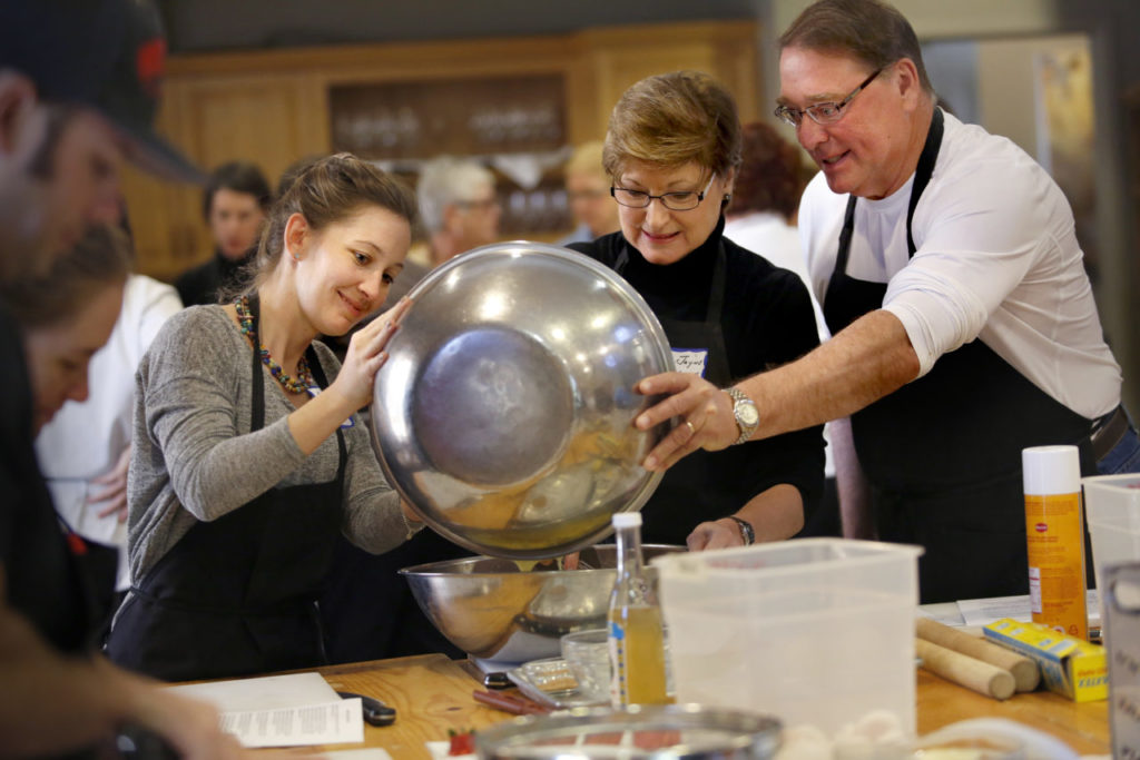 (From left) Anne Marie Streett, Mary Jayne Sullivan and her husband Mark, combine ingredients to make a Neapolitan Easter Pie with rice, ricotta and candied orange peel during an Italian Easter Feast cooking class at Ramekins Culinary School, Events, and Inn on Sunday, March 1, 2015 in Sonoma, California . (BETH SCHLANKER/ The Press Democrat)