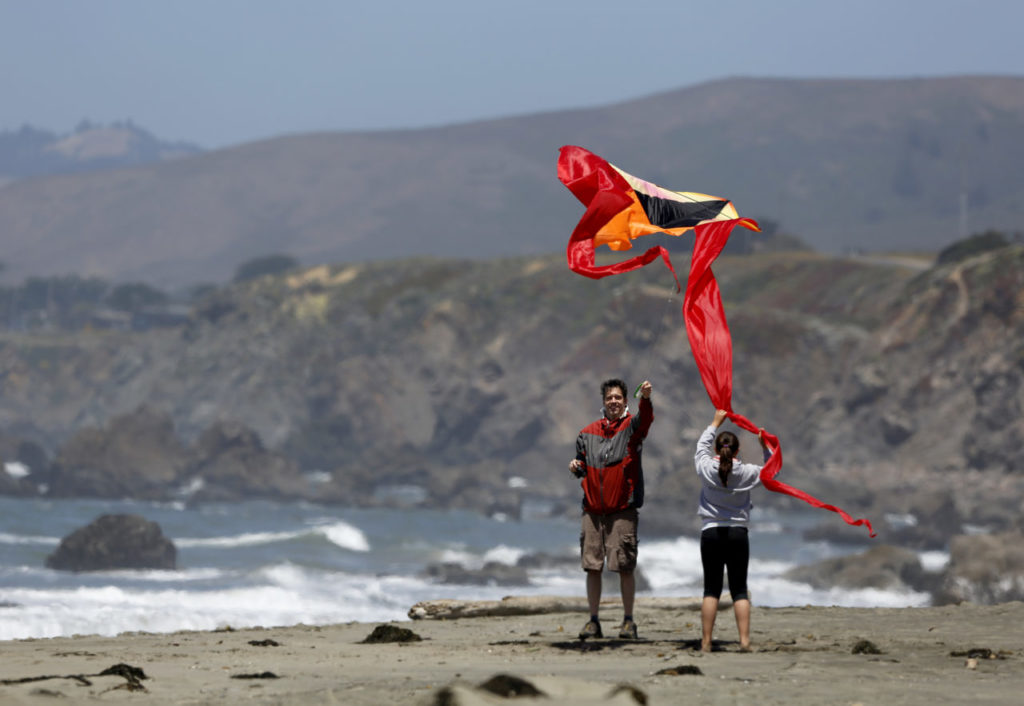 6/22/2014:A1: FUN AT THE BEACH: Steffen Layer and his daughter Layna,12, f Santa Rosa fly a kite last week at North Salmon Creek Beach north of Bodega Bay, part of Sonoma Coast State Park. A state proposal to expand day-use fees at more than a dozen beaches has been met with protest from North Coast residents. PC: Steffen Layer and his daughter Layna, 12, of Santa Rosa fly a kite at North Salmon Creek beach near Bodega Bay, on Tuesday, June 17, 2014.(BETH SCHLANKER/ The Press Democrat)