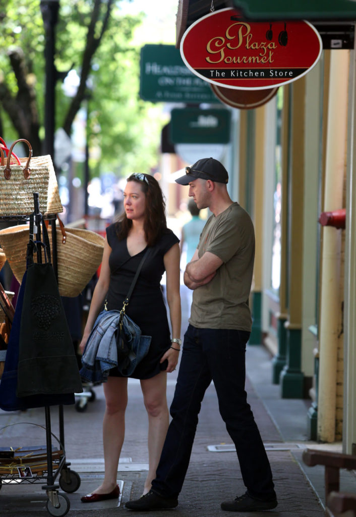 Theresa and Adam Ronan, visiting from Santa Fe, New Mexico, shop in Healdsburg Plaza on Monday, June 9, 2014. (Christopher Chung/ The Press Democrat)