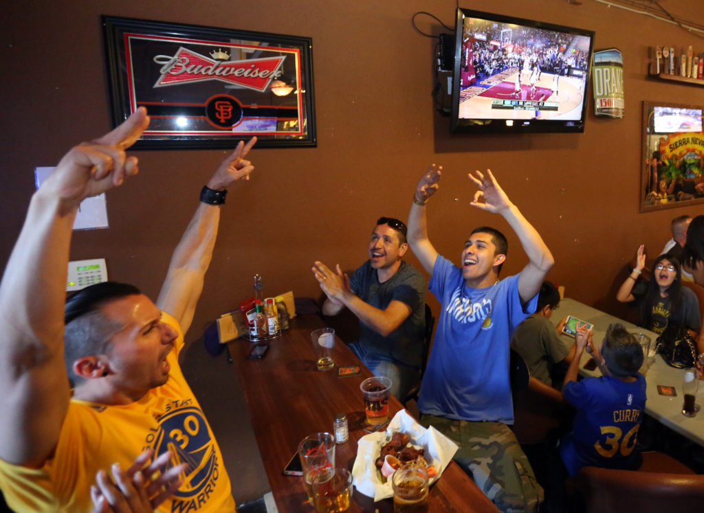 Fans watch and cheer at Sprenger's Tap Room in downtown Santa Rosa as the Golden State Warriors win their first NBA title in 40 years, Tuesday, June 16, 2015. (CRISTA JEREMIASON / The Press Democrat)