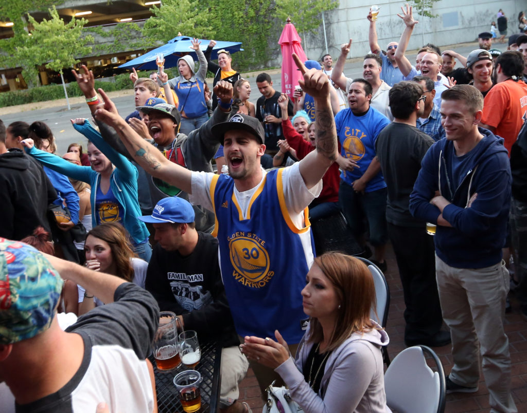 Fans watch and cheer at Sprenger's Tap Room in downtown Santa Rosa as the Golden State Warriors win their first NBA title in 40 years, Tuesday, June 16, 2015. (CRISTA JEREMIASON / The Press Democrat)