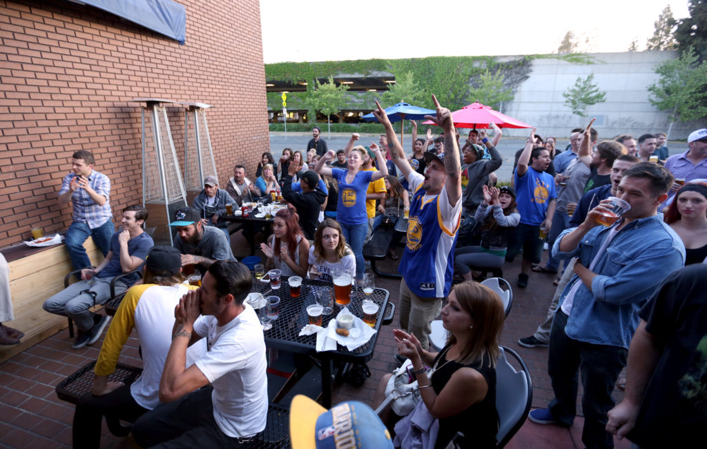 Fans watch and cheer at Sprenger's Tap Room in downtown Santa Rosa as the Golden State Warriors win their first NBA title in 40 years, Tuesday, June 16, 2015. (CRISTA JEREMIASON / The Press Democrat)