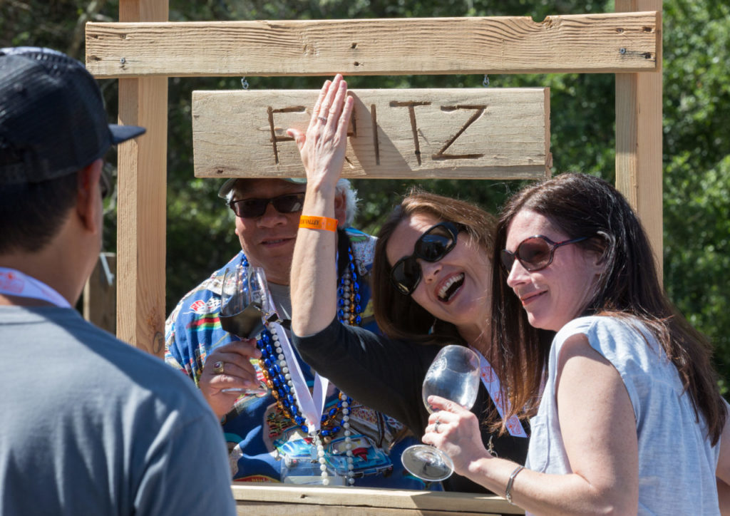 Guests take a photo with the Fritz Winery sign during the annual Passport to Dry Creek Valley near Geyserville, Calif. Saturday, April 25, 2015. Over 60 wineries and 150 growers in the Dry Creek Valley opened their doors to to tasters participating in the event.