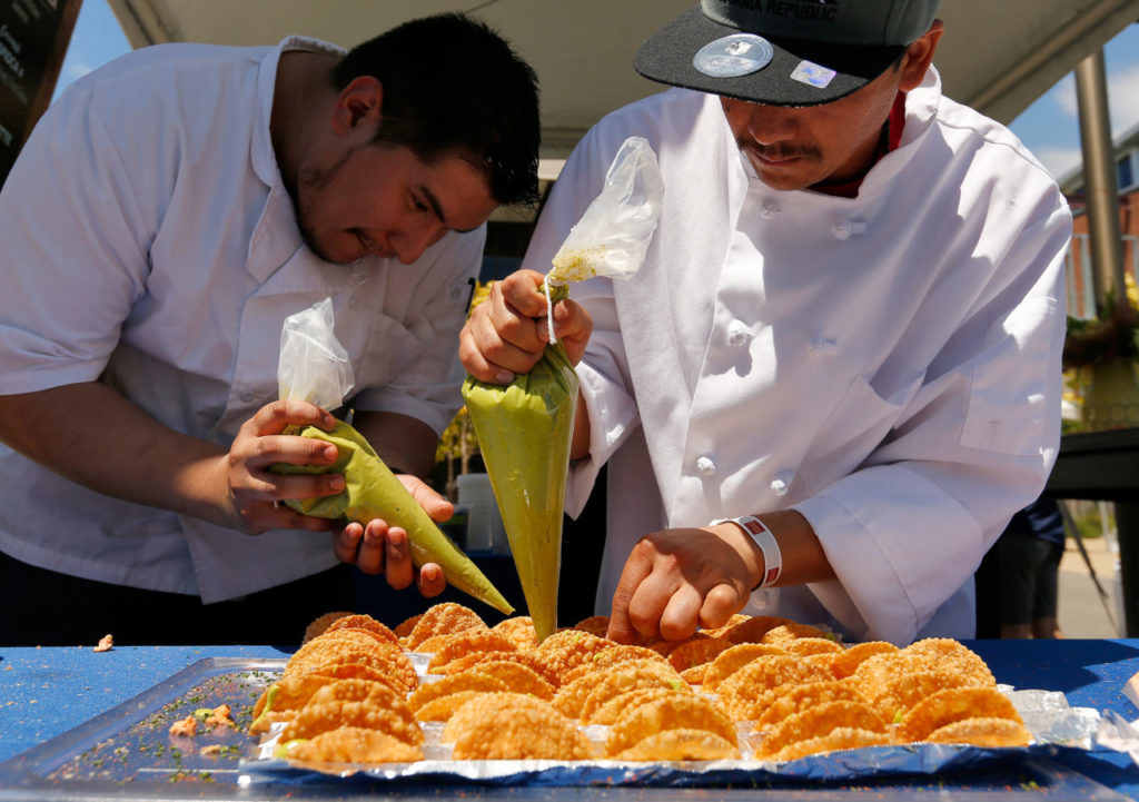 El Dorado Kitchen sous chef Jose Dominguez, left, and line cook Luis Correa make salmon rillette tacos during the North Coast Food and Wine Festival at Sonoma Mountain Village in Rohnert Park, California, on Saturday, June 10, 2017. (Alvin Jornada / The Press Democrat)
