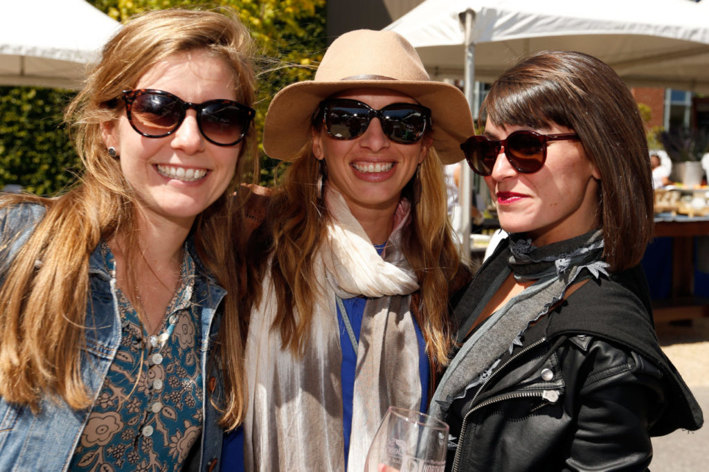 Penelope Mitchell, left, Courtney Clamp and Chelsea Morris attend the North Coast Food and Wine Festival at SOMO Village in Rohnert Park, California, on Saturday, June 10, 2017. (Alvin Jornada / The Press Democrat)