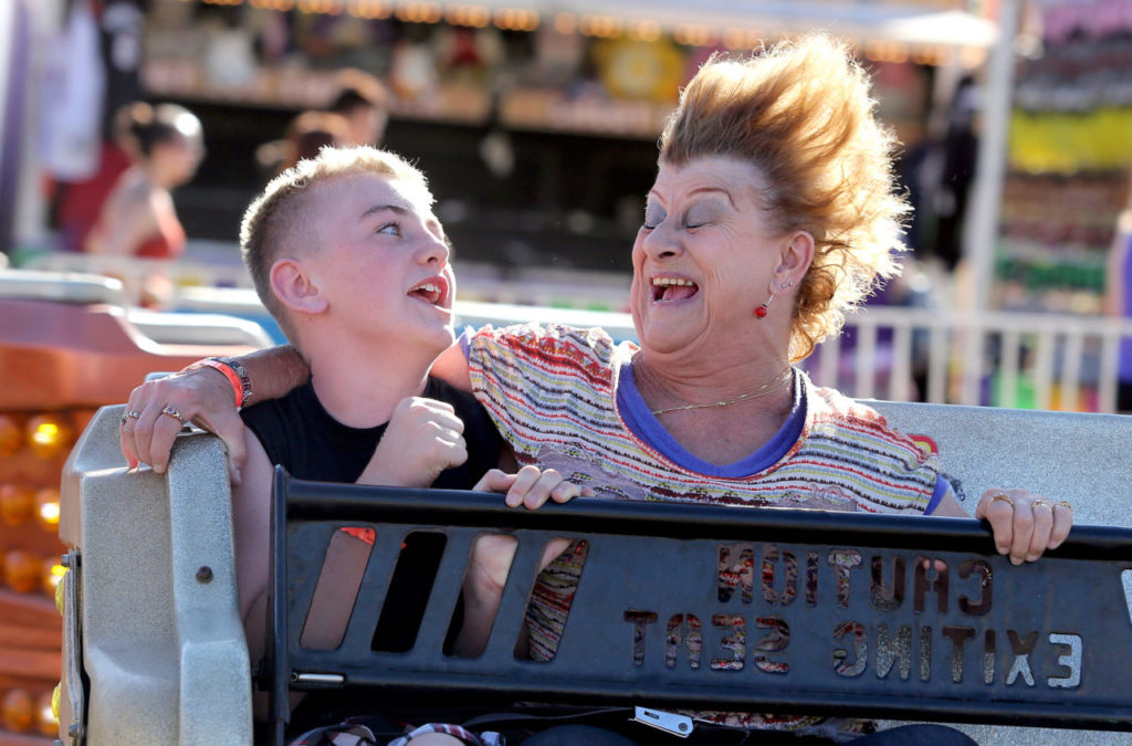 7/25/2014:B1: FAMILY FUN: Joseph Wilson, 10, and his grandmother Anne Bradley of Santa Rosa ride the Sizzler on Thursday, the opening day of the Sonoma County Fair. PC: Joseph Wilson, 10, left, and his grandma Anne Bradley, right, of Santa Rosa road the "Sizzler," during opening day at the Sonoma County Fair, Thursday, July 24, 2014. (Crista Jeremiason / The Press Democrat)