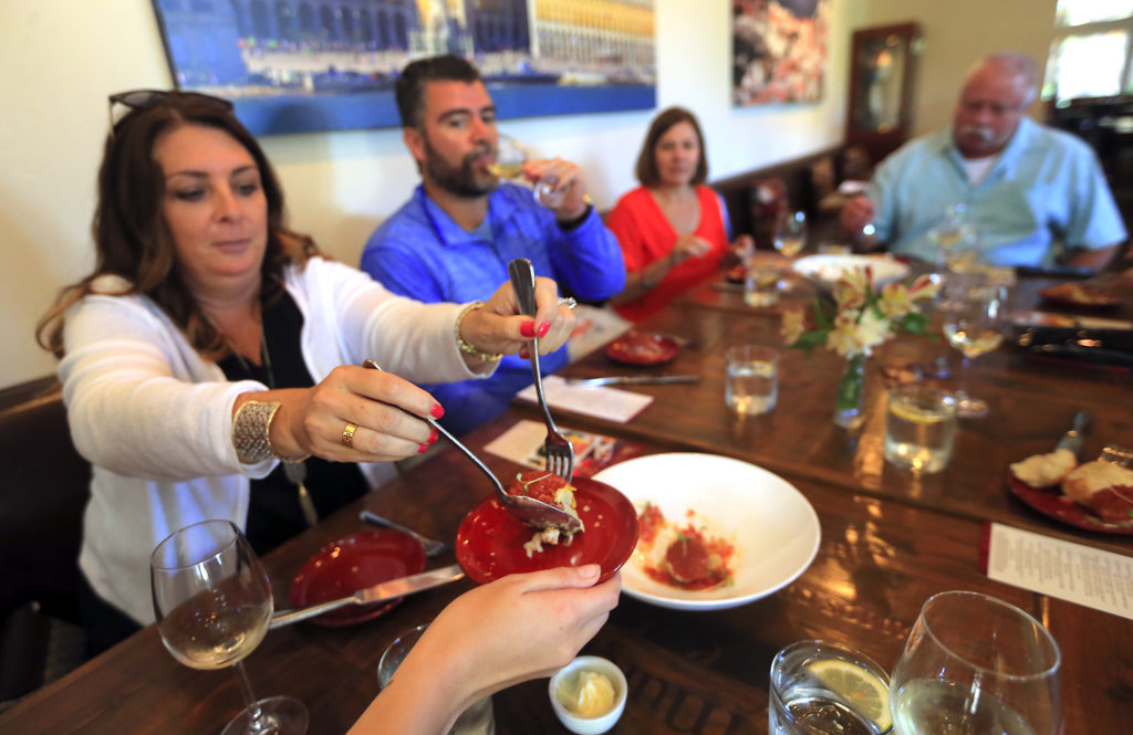 Left to right, Kristina and Al Wilson serve up scallops at Cafe Lucia on a culinary tour with Tammy Gass, operator of Savor Healdsburg Food Tours on Thursday, August 4, 2016. (JOHN BURGESS/The Press Democrat)