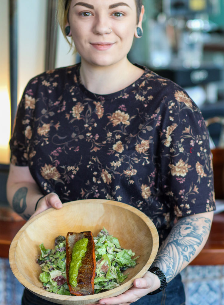 A server shows McFarland Spring Trout salad at Pearl restaurant in Petaluma. heather irwin/PD