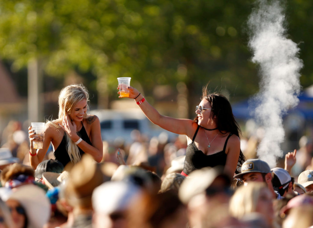 Concertgoers get above the audience to enjoy the show during day two of Country Summer at the Sonoma County Fairgrounds in Santa Rosa, California, on Saturday, June 17, 2017. (Alvin Jornada / The Press Democrat)