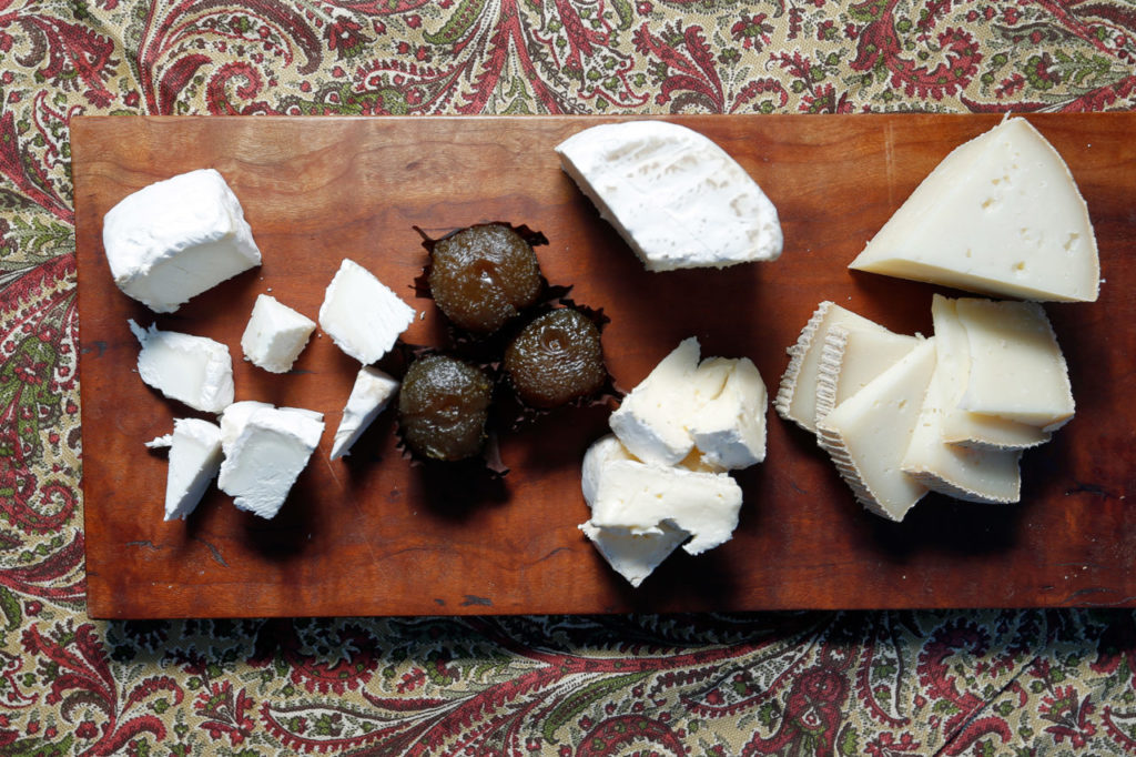 One half of a cheese plate assembled by Omar Mueller, featuring (from left to right) Pennyroyal Farm Bollie's Mollies, Amexia D'Elvas Convento de Serra natural preserved plums, Cowgirl Creamery Mt. Tam triple-cream, and Bleating Heart Cheese Fat Bottom Girl, at Freestone Artisan Cheese, in Freestone, California on Tuesday, November 29, 2016. (Alvin Jornada / The Press Democrat)