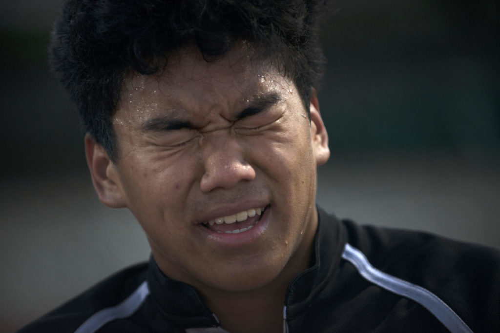 Lobo Rugby Club player David Klaut, 17, grimacing in pain from a knee injury he had during a playoff game against Center Parkway Harlequins from Sacramento held at Elsie Allen High School in Santa Rosa. April 28, 2017. (Photo: Erik Castro/for The Press Democrat)