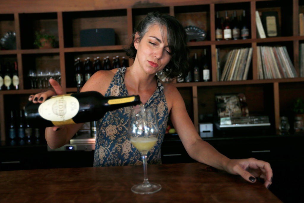 Suzanne Hagins pours a glass of Hops and Honey hard cider at Horse and Plow winery in Sebastopol, California on Wednesday, July 27, 2016. (Alvin Jornada / The Press Democrat)