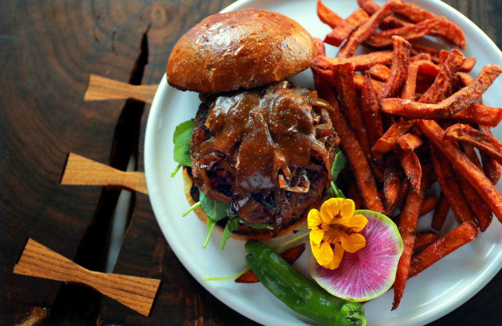 Grilled Veggie Burger with bbq sauce, vegetable cashew cream cheese and caramelized onion and a side of sweet potato fries from the Drawing Board restaurant in Petaluma. (photo by John Burgess/The Press Democrat)