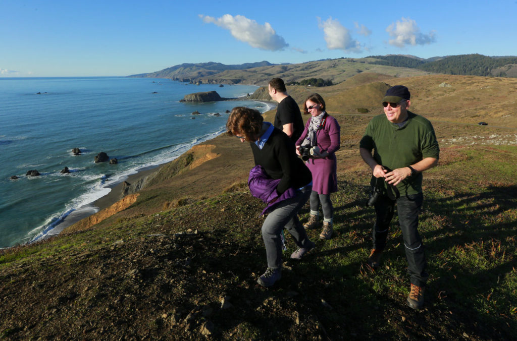 (l to r) Frieda Ireland, Jonathan Posit, Sara and Carroll Damron enjoy the view on the bluffs above Goat Rock beach in Jenner on Thursday. (JOHN BURGESS / The Press Democrat)