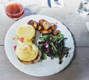 Eggs Benni with house potatoes, salad and unfiltered sparkling wine at Naked Pig in Santa Rosa. Heather Irwin/PD