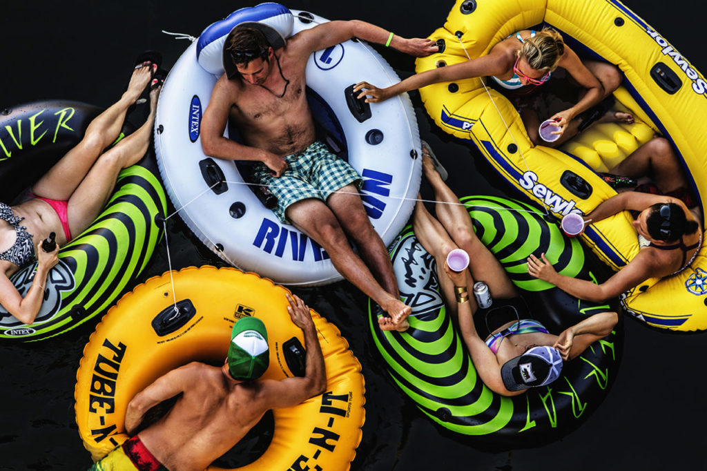 Looking down on a small group of young men and women floating on the Russian River.