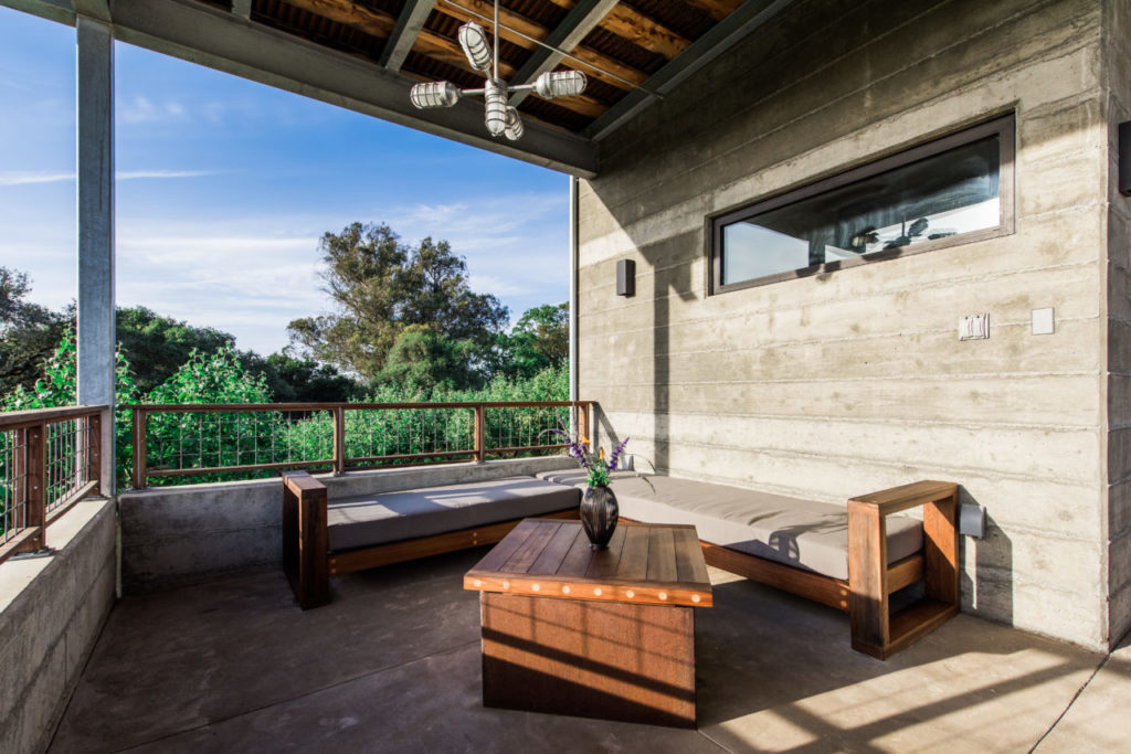 Salvaged wine tank redwood table and sectional made by Jesse Almos of Sonoma Woodworks.