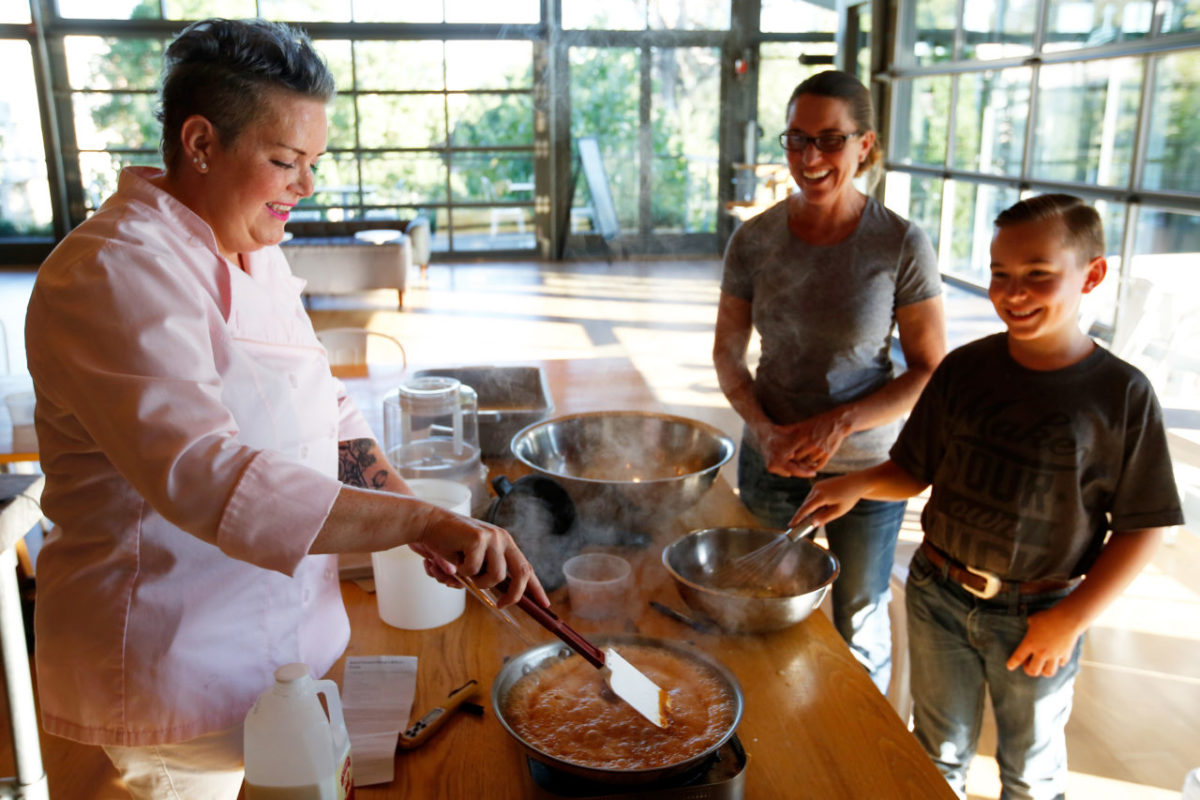 Maria deCorpo, left, of Real Cool Frozen Treats helps Steph Meesey and her son Patrick, 10, with a batch of caramel for a salted caramel sheep's milk ice creat during an ice cream making class at SHED in Healdsburg, California on Wednesday, July 26, 2017. (Alvin Jornada / The Press Democrat)