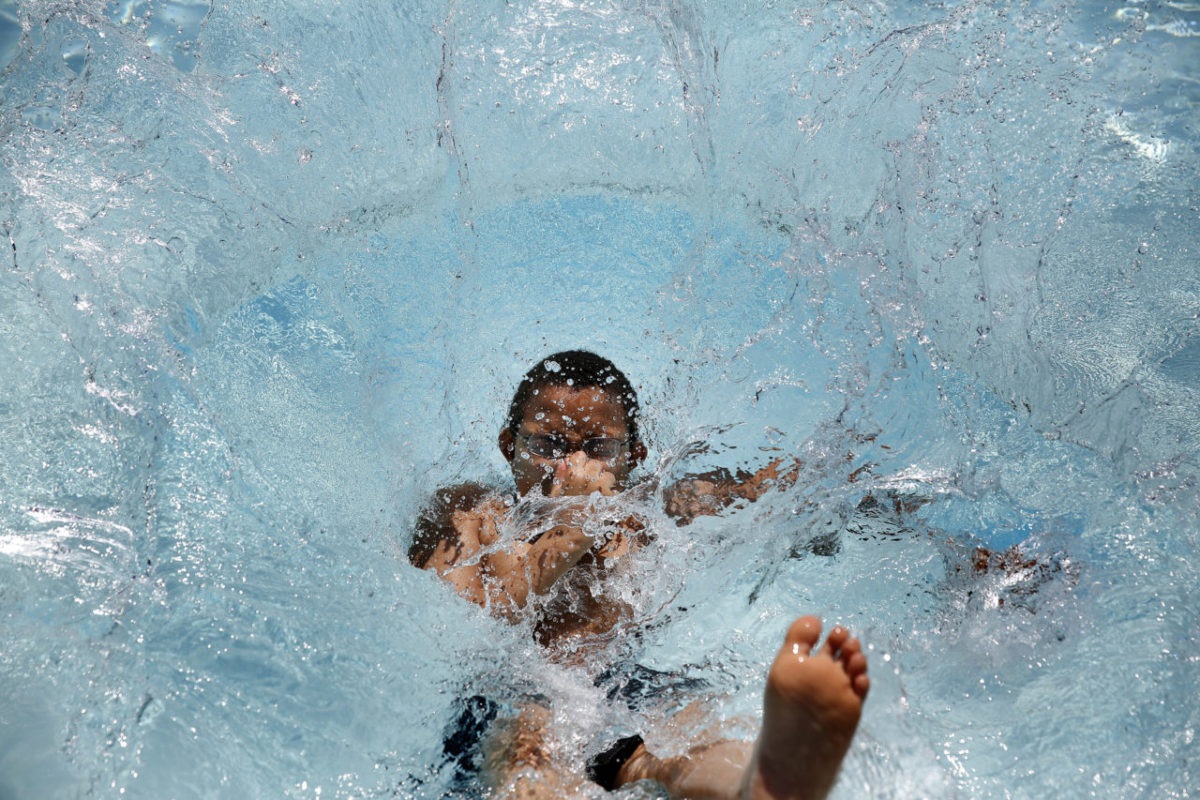 Alex Moore jumps into the pool at the San Francisco North / Petaluma KOA campground on Tuesday, May 28, 2013 in Petaluma, California. (BETH SCHLANKER/ The Press Democrat)