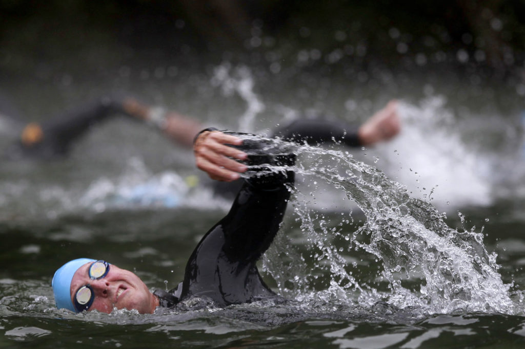 A competitor swims in the Russian River during the Ironman 70.3 Vineman Triathlon at Johnson's Beach in Guerneville, on Sunday, July 13, 2014. (BETH SCHLANKER/ The Press Democrat)