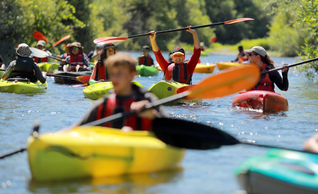 Ellie Wood, 13, raises her paddle in celebration during the LandPaths Russian River Teen Trek covering 21 miles over three days. (photo by John Burgess/The Press Democrat)