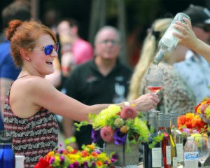 Amy Babiuch of Cleveland holds her glass out for the last drop of a rose at the Taste of Sonoma at the Green Music Center on the SSU campus on Saturday, September 2, 2017. (photo by John Burgess/The Press Democrat)