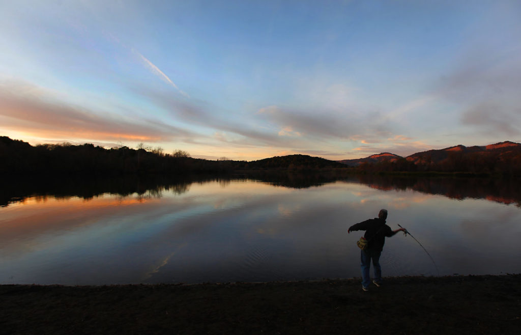 12/28/2011: B1: PC: Gordon Suvoy fishes by twilight at Spring Lake, Tuesday Dec. 27, 2011. Fishing weather will remain in place for the next few days, a threat of light rain is in the forecast beginning Friday. (Kent Porter / Press Democrat) 2011