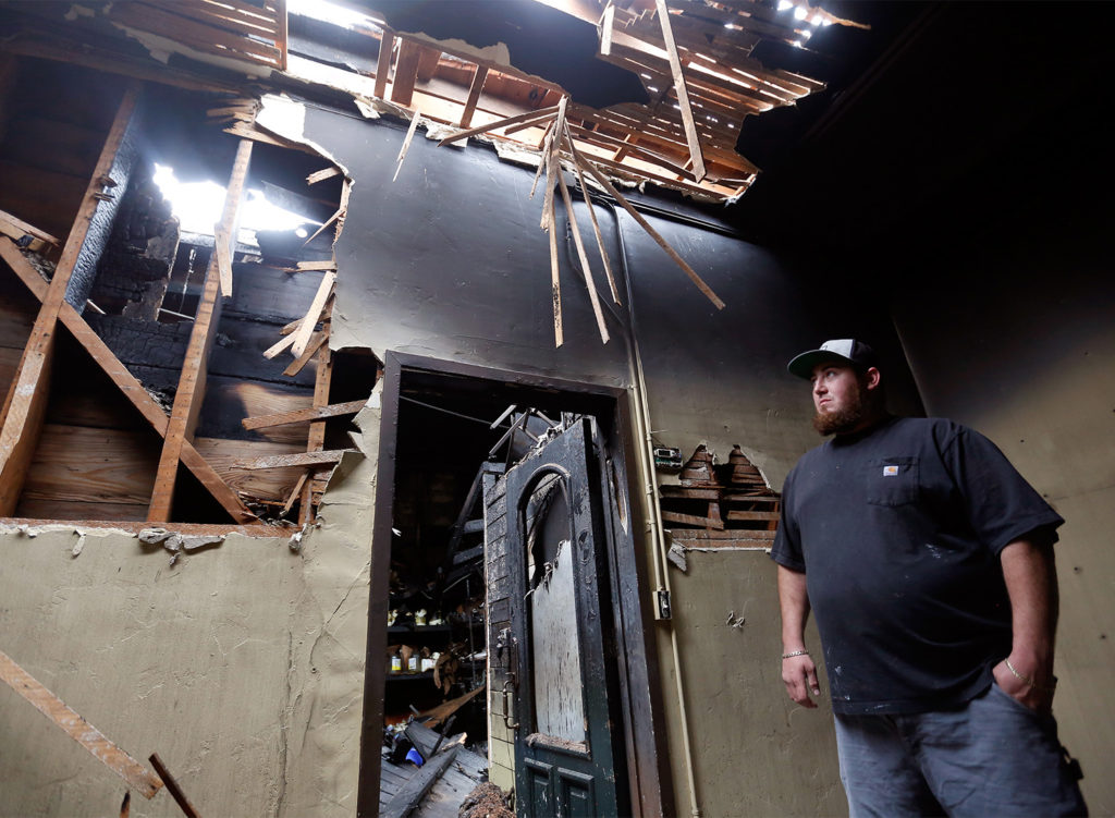 Nick Svedise, whose family owns Santa Rosa Seafood, stands beside the door to a storage area where a two-alarm fire originated, at Santa Rosa Seafood, in Santa Rosa, California, on Saturday, May 5, 2018. (Alvin Jornada / The Press Democrat)