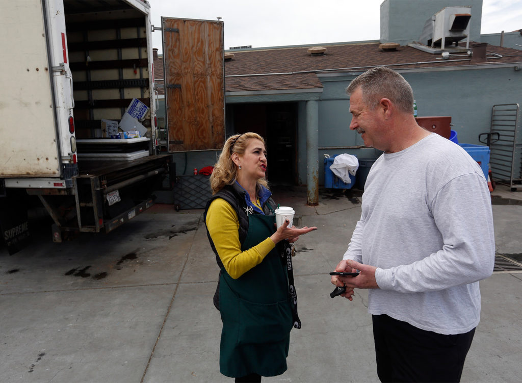 Trudy Svedise, right, whose family owns Santa Rosa Seafood, takes a moment to talk with regular customer Tim Hylas of Geyserville to explain that her business is closed for the day due to a fire that happened inside one of the storage rooms at Santa Rosa Seafood, in Santa Rosa, California, on Saturday, May 5, 2018. (Alvin Jornada / The Press Democrat)