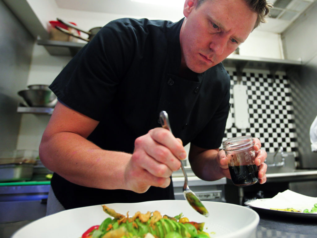 Ryan Fancher, chef of Barndiva, prepares a dish that includes beets, heirloom tomatos, garlic, artichokes, tempura green beans, fava beans carrots and a basil oil. (NOTE : they didn't have official recipe when there, said they would be sending to Diane)