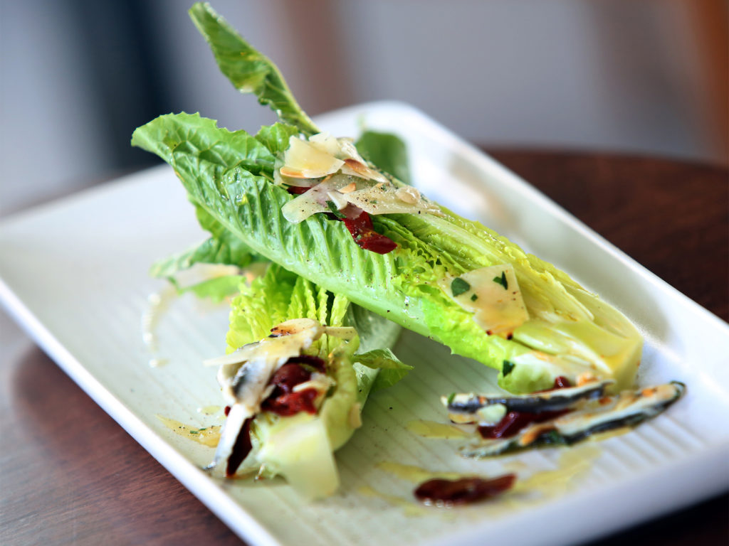 Today's Salad, which is romaine lettuce with shaved Parmigiano-Reggiano, anchovies and almonds served at Vignette at The Barlow in Sebastopol, Tuesday, September 16, 2014. (Crista Jeremiason / The Press Democrat)