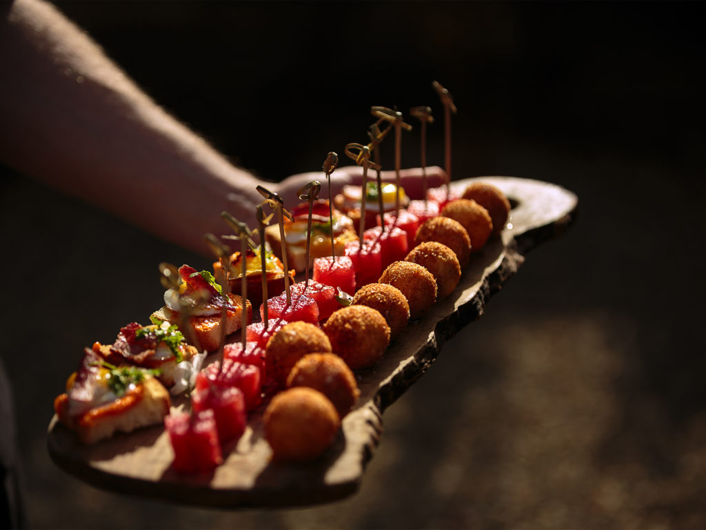 hors-d'oeuvres of Barndiva Quail Egg 'BLT's' on crostini, honey and lavender infused lemon verbina watermelon, and goat cheese croquettes. Wedding at Barndiva